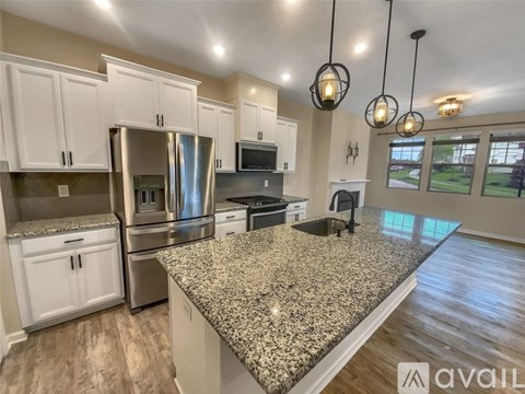 A kitchen with granite countertops and stainless steel appliances.