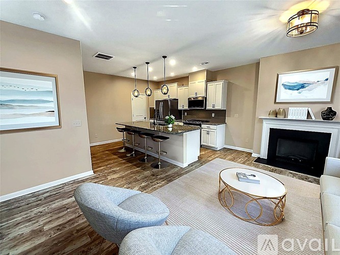 A living room with a grey chair and a white sofa.