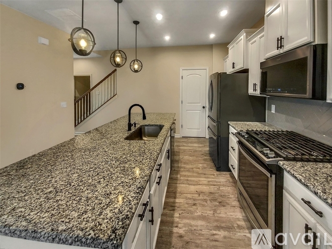 A kitchen with granite countertops and stainless steel appliances.