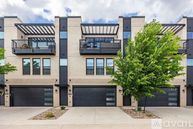 A modern building with balconies and garages is available for purchase.