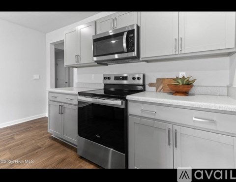 A kitchen with a stove top oven and microwave above it.