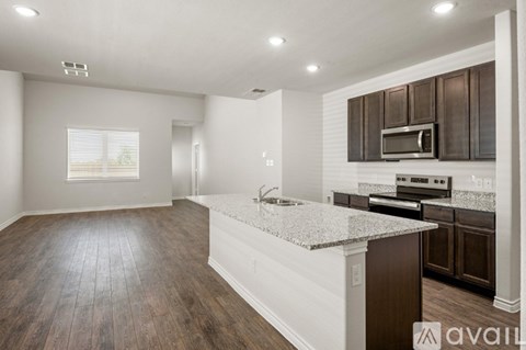 A kitchen with brown cabinets and a white island.