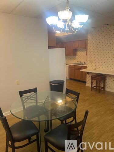 A dining room with a glass table and chairs.