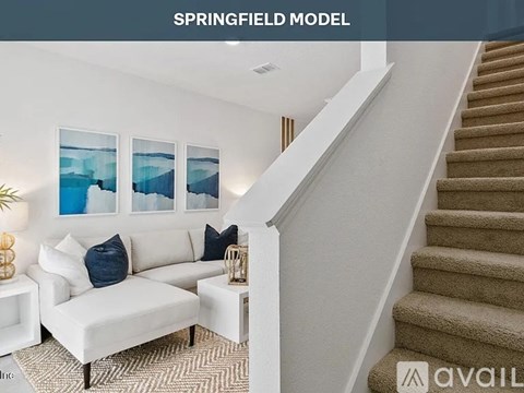 A living room with a staircase and a couch.
