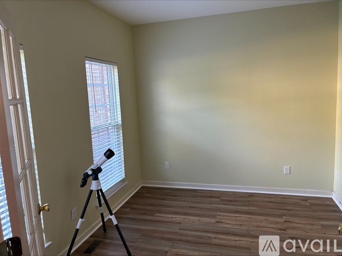 A room with a tripod and a window.