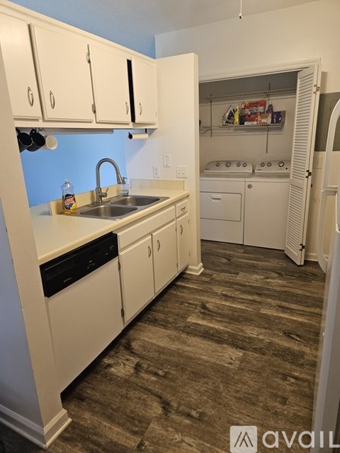 A kitchen with white cabinets and a sink.