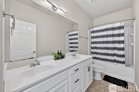 A bathroom with a white sink and a white toilet.