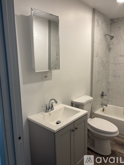A bathroom with a sink, toilet, and bathtub.