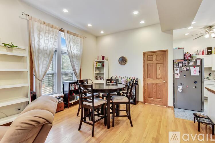 A kitchen with a table and chairs in the middle of the room.