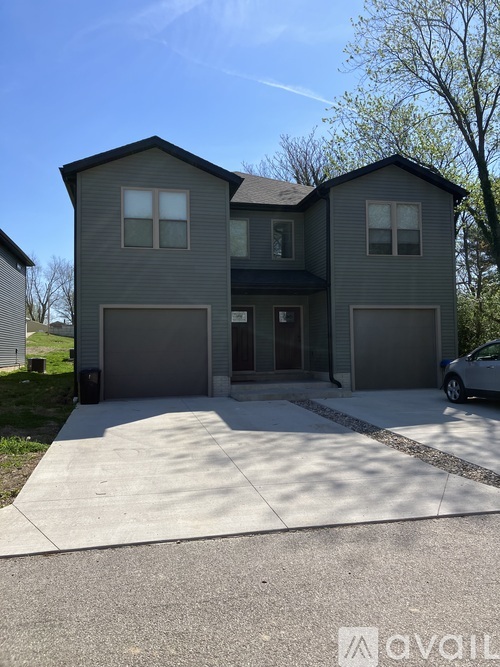 A two-story house with a garage is available for sale.