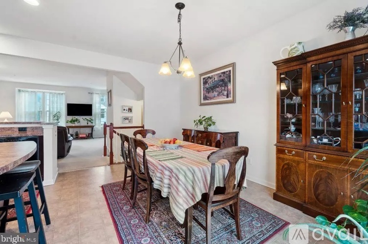 A dining room with a wooden table and chairs.