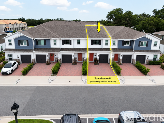 A row of houses with a yellow arrow pointing to the second house from the left.