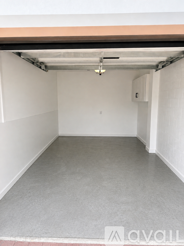 A spacious garage with a concrete floor and white walls.