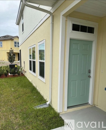 A house with a blue door and a white frame.