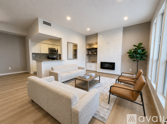 A living room with a grey couch, a coffee table, and a fireplace.