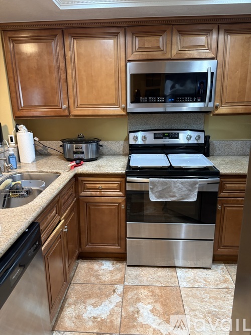 A kitchen with a stove top oven and microwave above it.