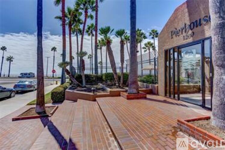 A brick walkway leads to a building with a sign that reads Pier House.