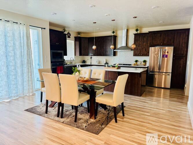 A modern kitchen with a dining table set for four.