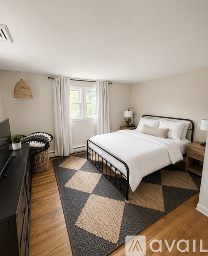 A bedroom with a large bed and a television.
