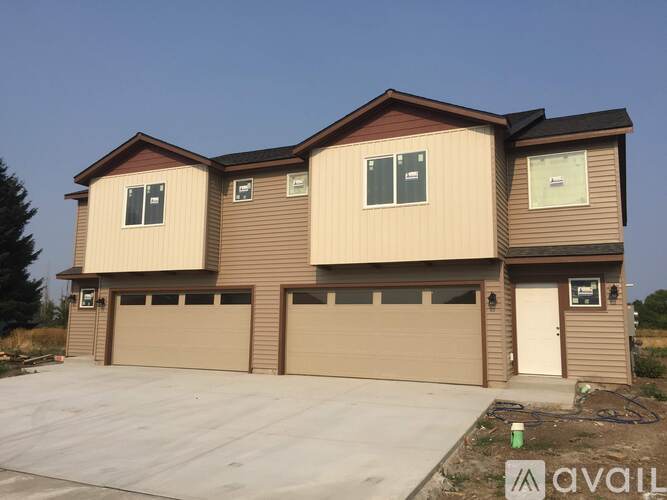 A two-story house with a garage is available for sale.