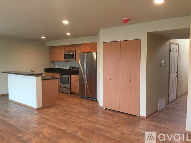 A kitchen with wooden floors and a white counter.