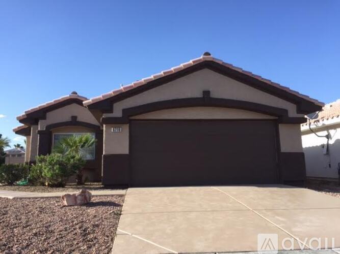 A house with a brown roof and a garage door.