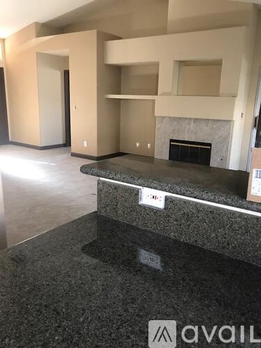A living room with a fireplace and a grey countertop.