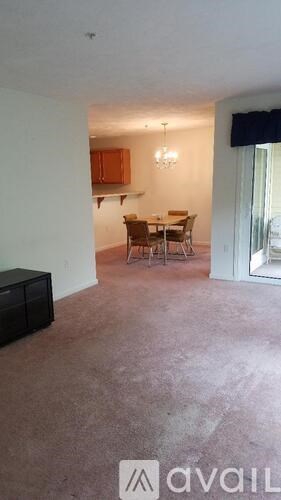 A living room with a dining table and chairs.