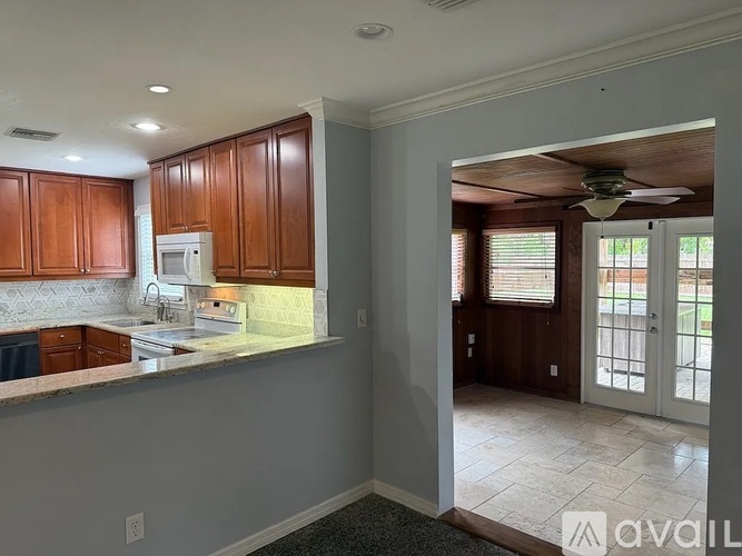 A kitchen with wooden cabinets and a white fridge.