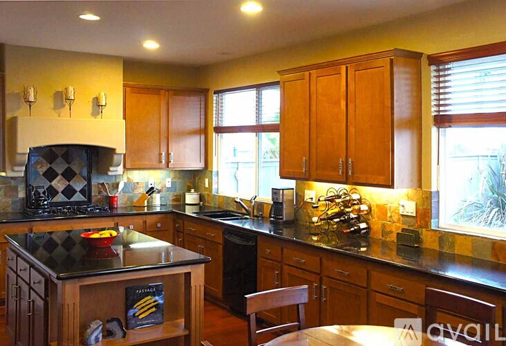 A kitchen with wooden cabinets and a black and white checkered stove top.