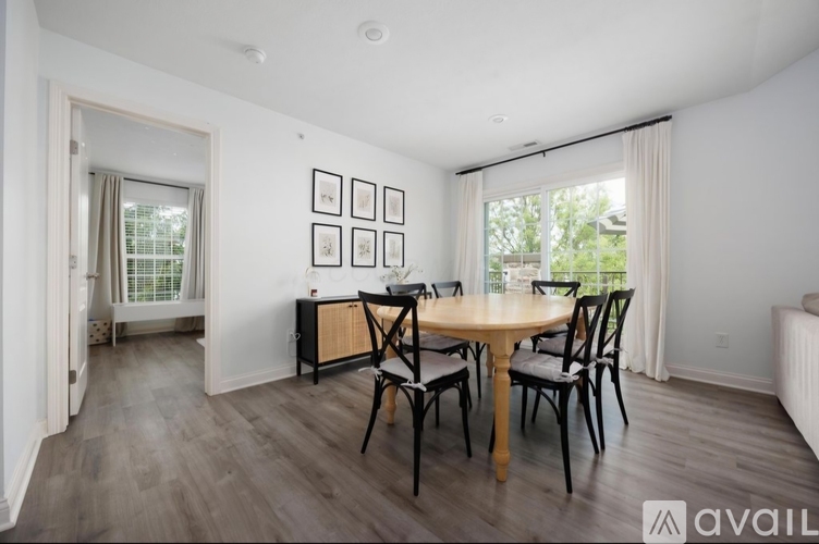 A dining room with a wooden table and chairs.