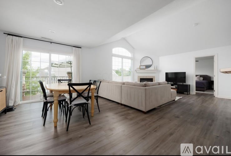 A modern living room with a dining table and chairs.