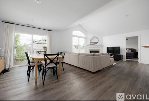 A modern living room with a dining table and chairs.