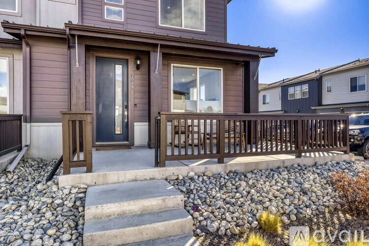 A house with a brown door and a wooden fence.