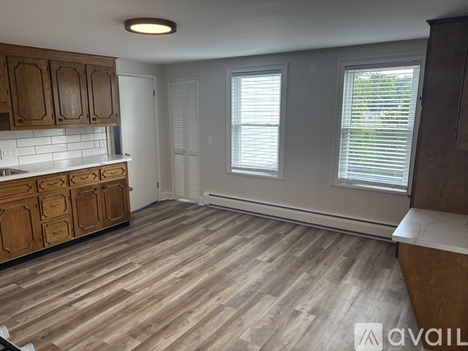 A kitchen with wooden cabinets and a countertop.