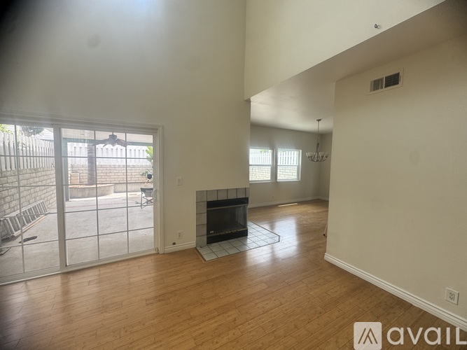 A living room with a fireplace and sliding glass doors.