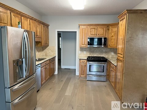 A kitchen with wooden cabinets and stainless steel appliances.