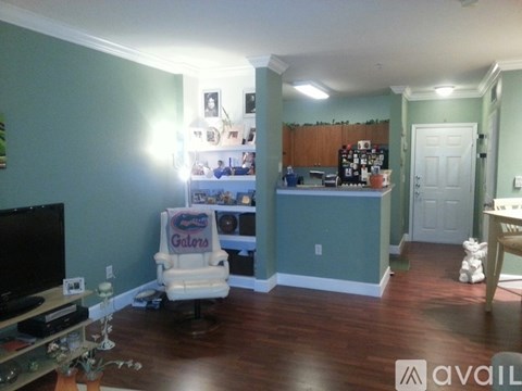 A living room with a television and a recliner chair.