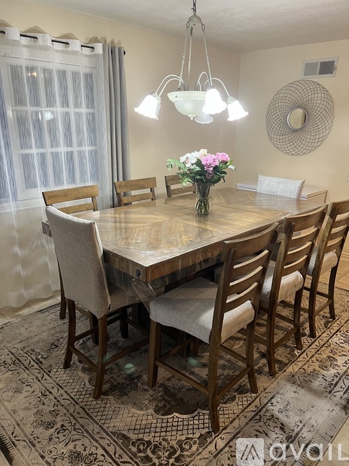 A dining room with a table set for six.