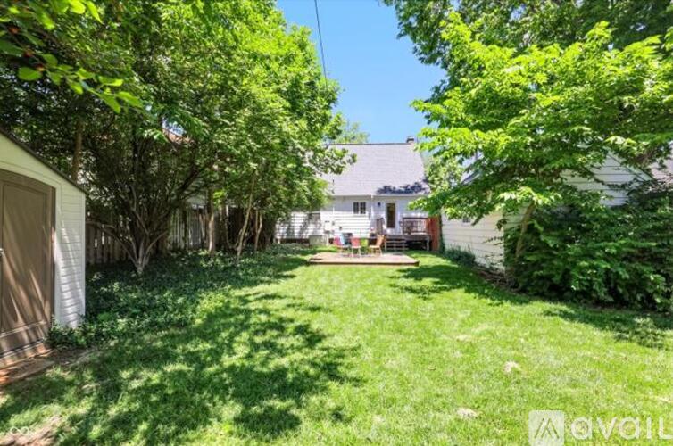 A backyard with a lawn and trees.