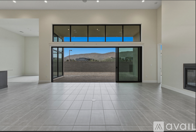 A spacious room with a view of the desert through the glass doors.