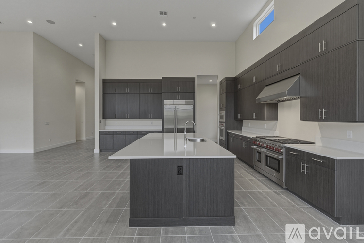 A modern kitchen with dark wood cabinets and a central island.