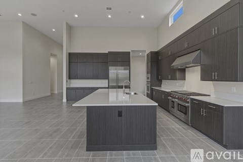 A modern kitchen with dark wood cabinets and a central island.