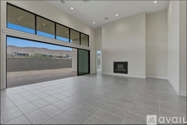 A spacious living room with a fireplace and large windows.