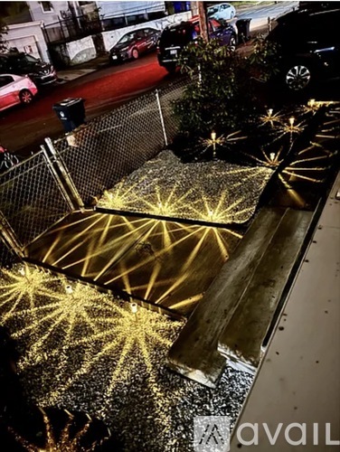 A golden light display is illuminated on a street.