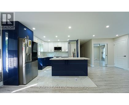 A modern kitchen with blue cabinets and a central island.