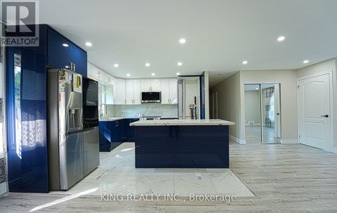 A modern kitchen with blue cabinets and a central island.