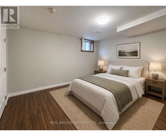 A bedroom with a bed, nightstands, and a framed picture on the wall.