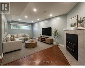 A living room with a fireplace and a television.