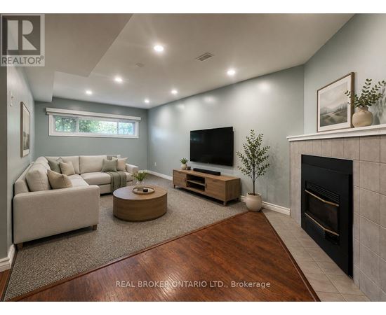 A living room with a fireplace and a television.